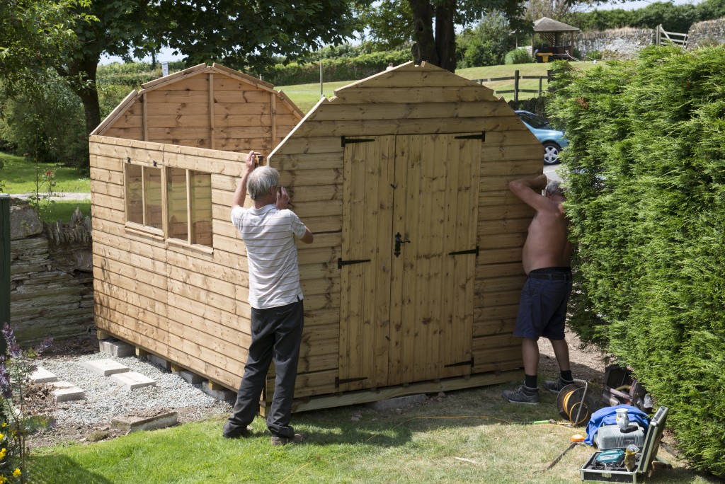 men building a small shed