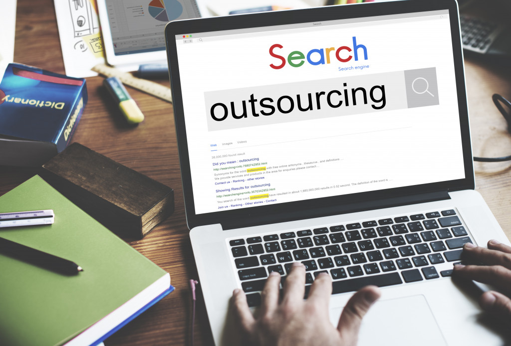 laptop screen displaying a SERP for outsourcing