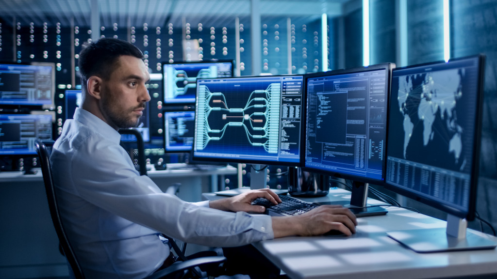 man using a high tech computer with multiple screens