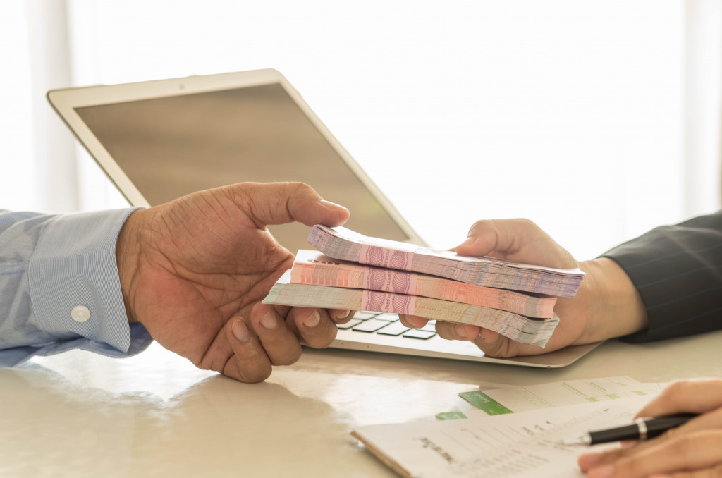 A businessman receiving money through a loan from a banker