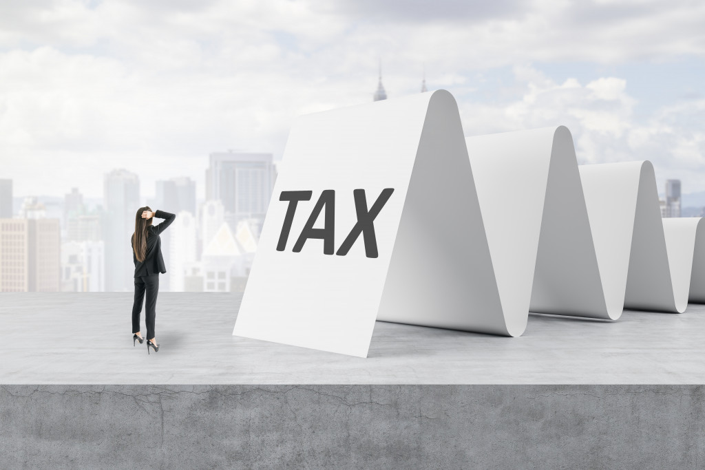 taxation concept woman looking at tax word