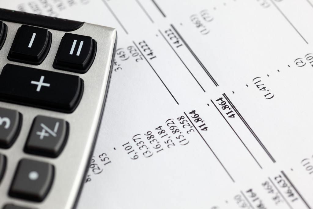 a calculator on top of a financial statement