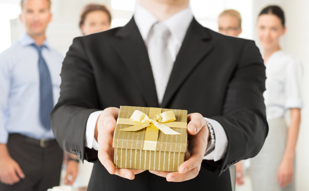 employee giving a gift box