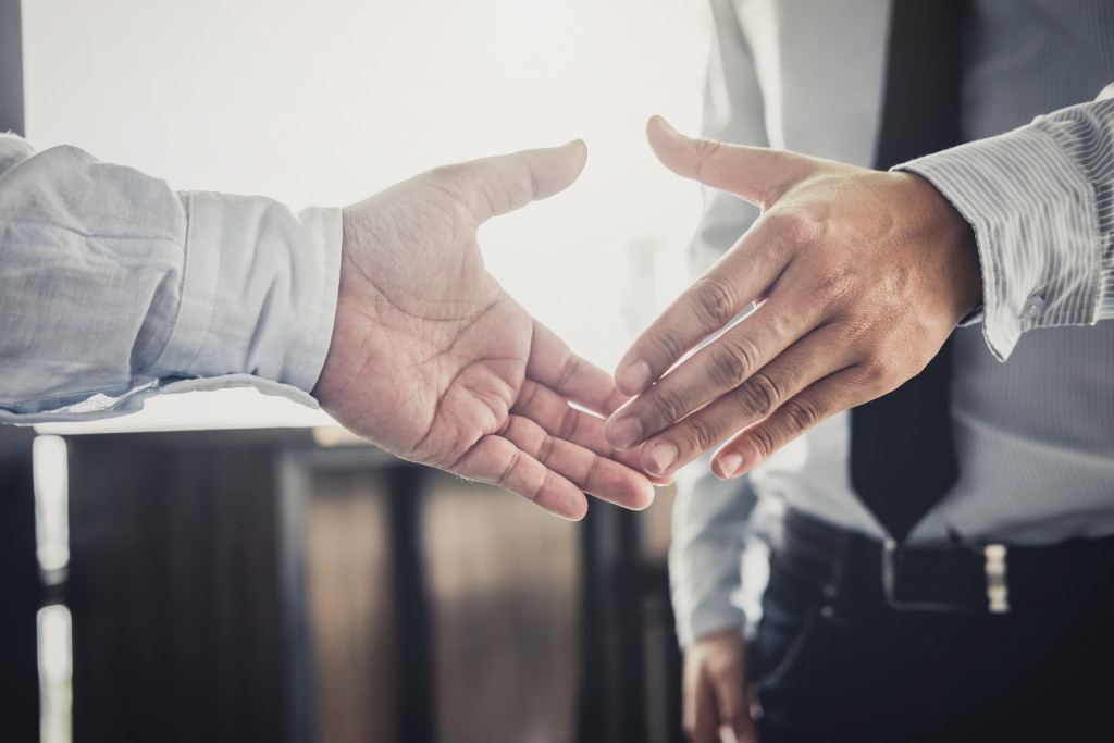 two businessman about to shake hands and closing a deal