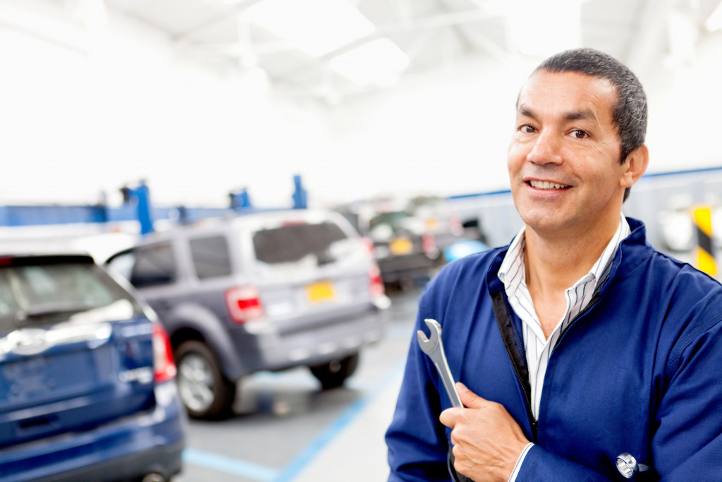 auto mechanic in the repair shop smiling