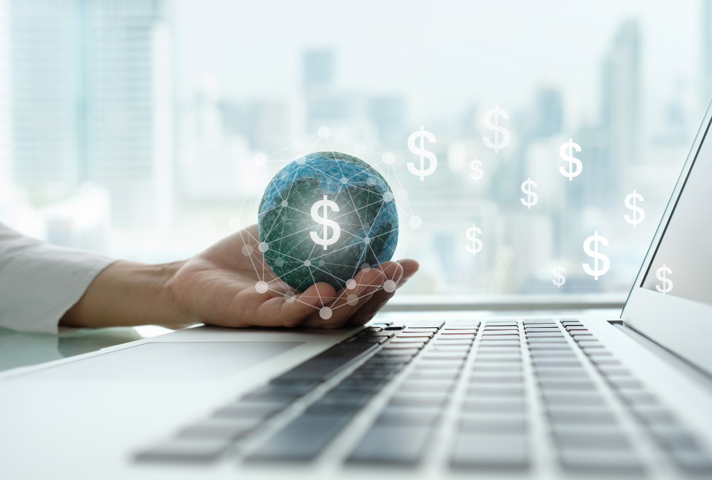 concept of international business growth businesswoman holding globe with dollar sign