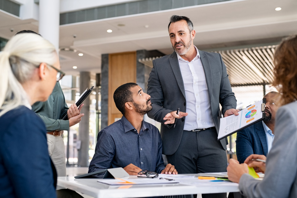 Businessman consulting a team of lawyers in an office.