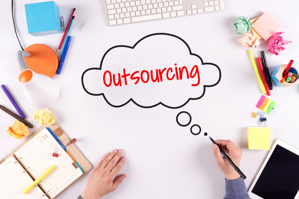 Outsourcing concept on a cluttered office desk