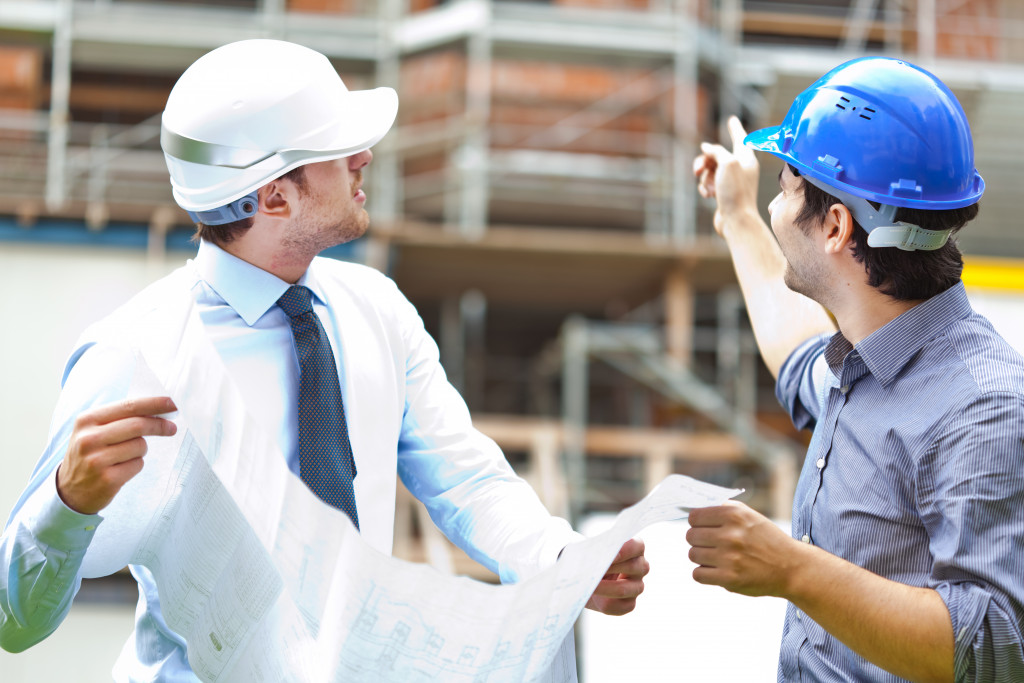 Engineers looking at a construction site blueprint