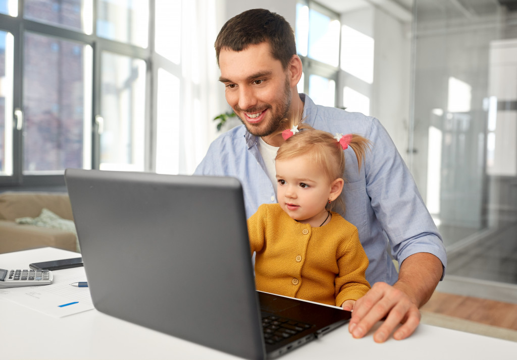 remote work dad with his daughter