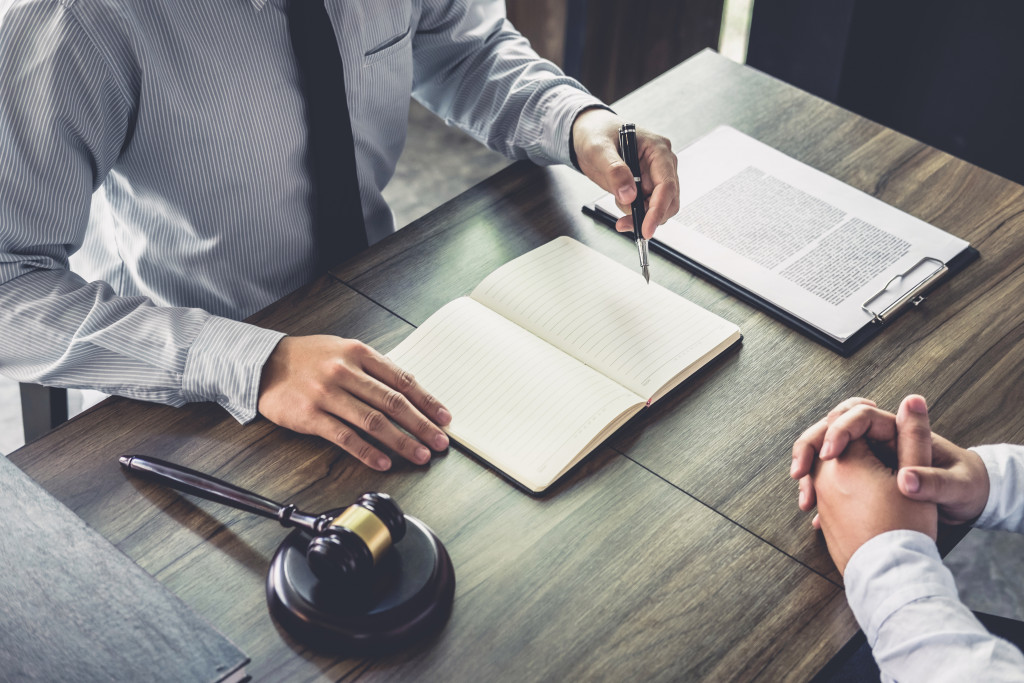 lawyer reviewing contracts and notes in an office with gavel on the side