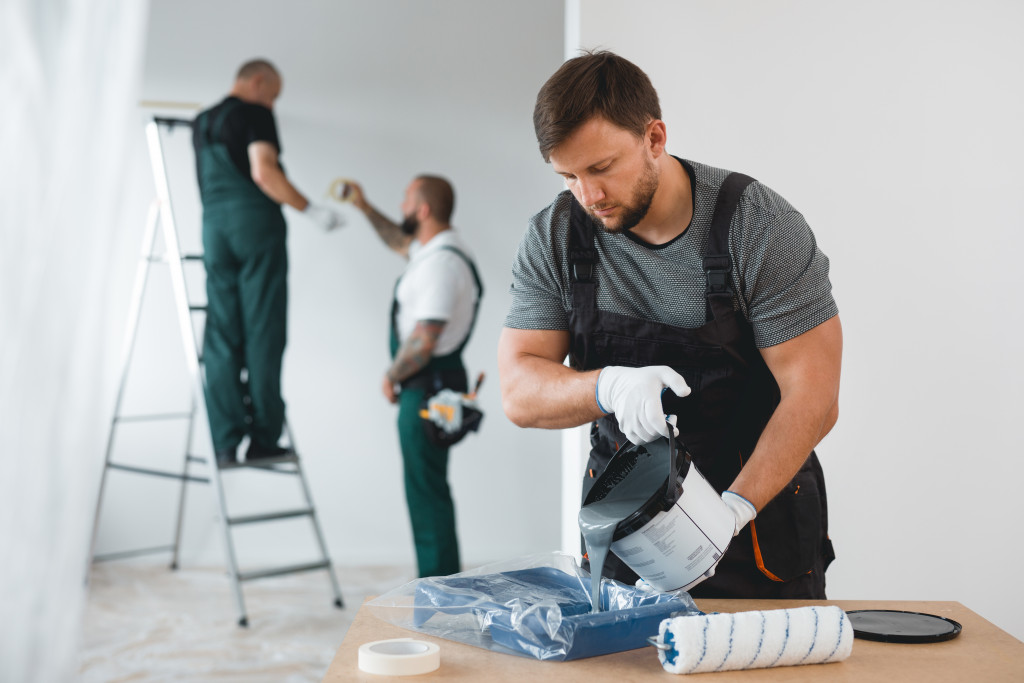 An image of workers painting walls