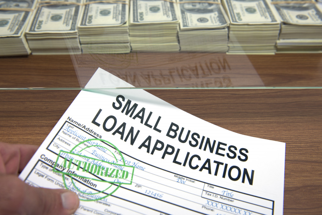 A small business loan application form with cash in front of it