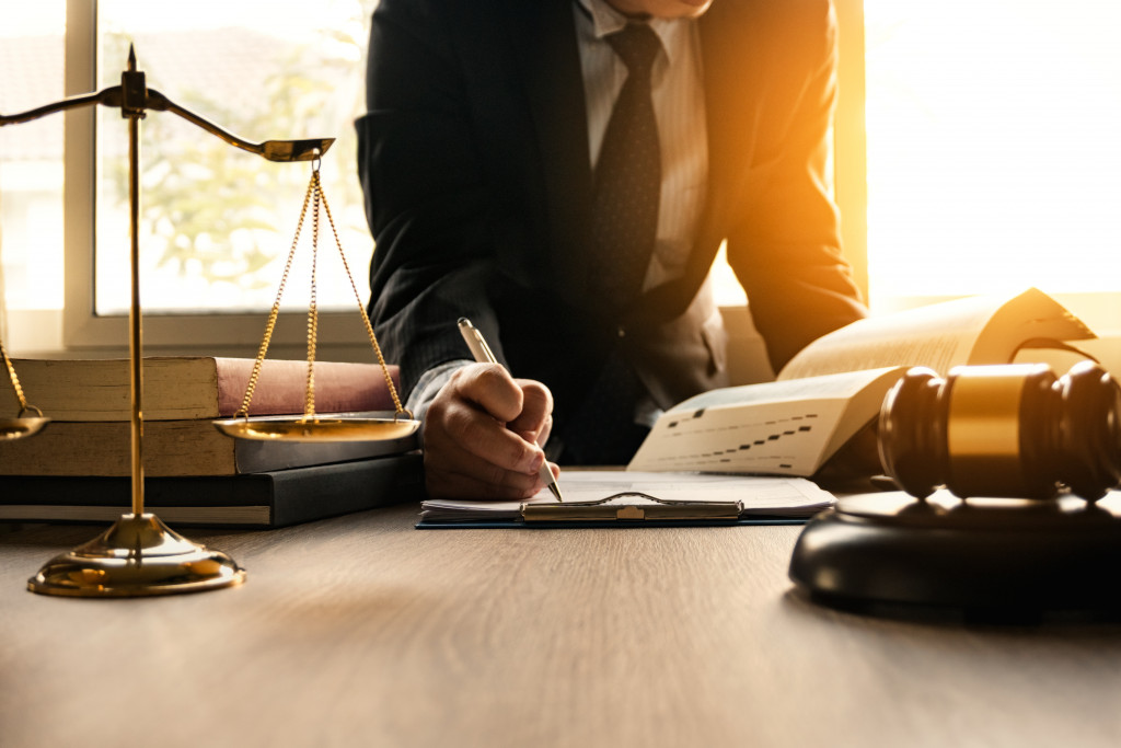 A lawyer writing on something on his desk