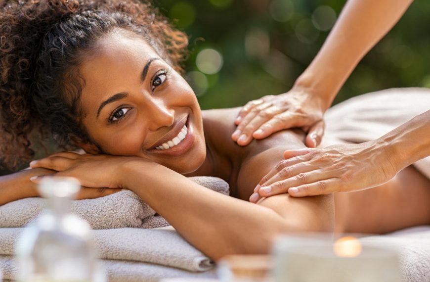 woman smiling in a medical spa getting massaged outdoors