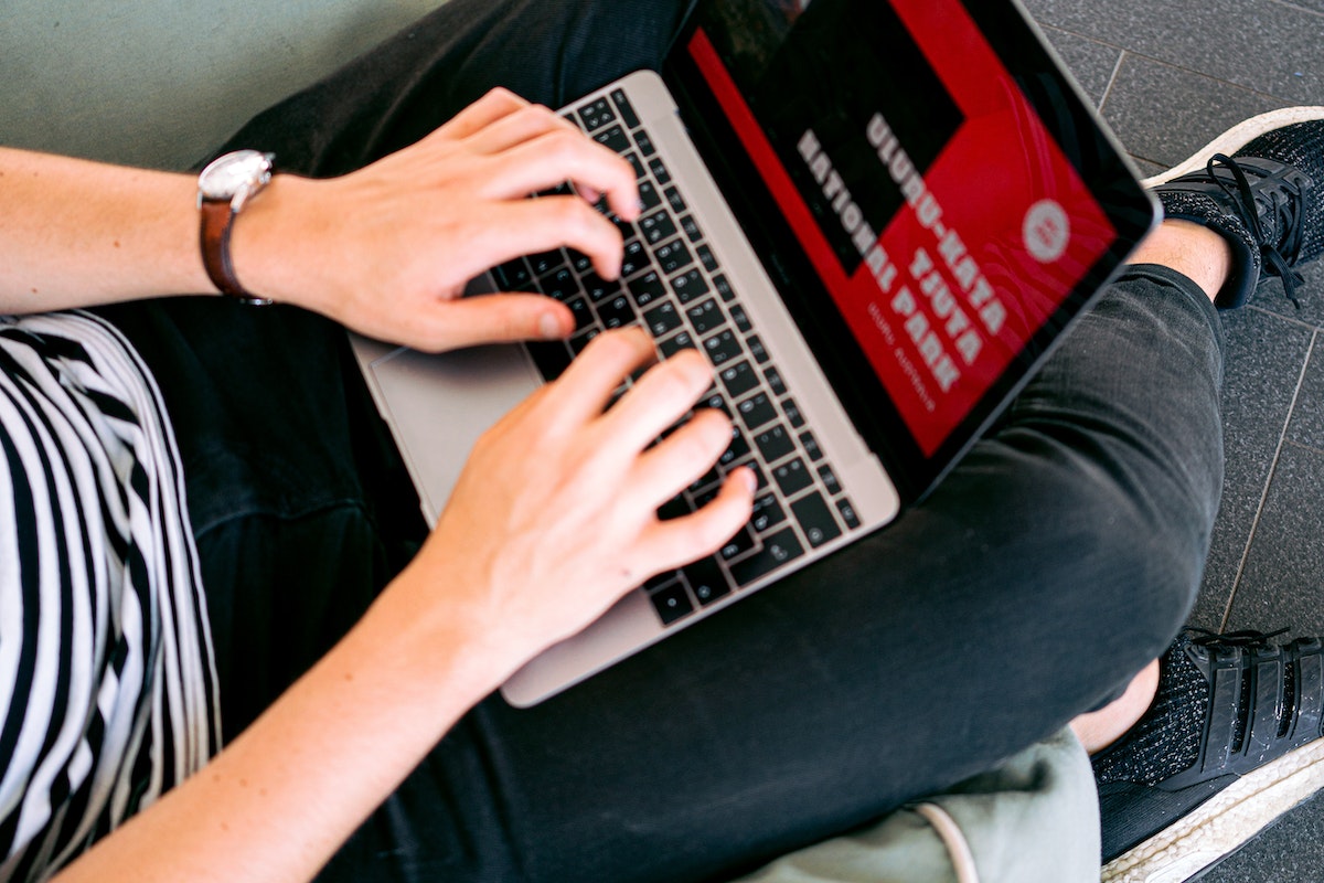 Man With Headphones Facing Computer Monitor