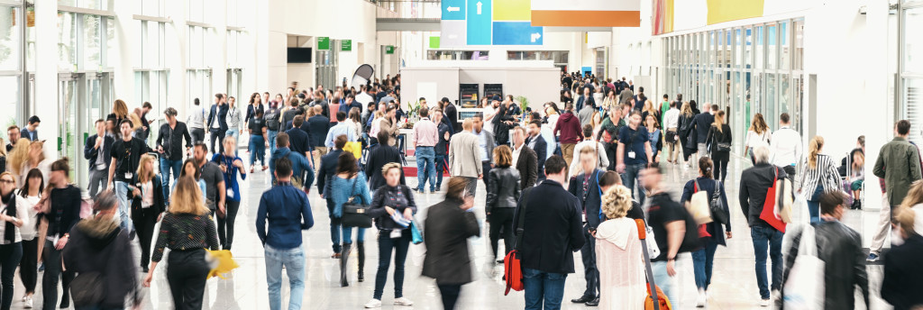 People attending a job fair at an event hall.